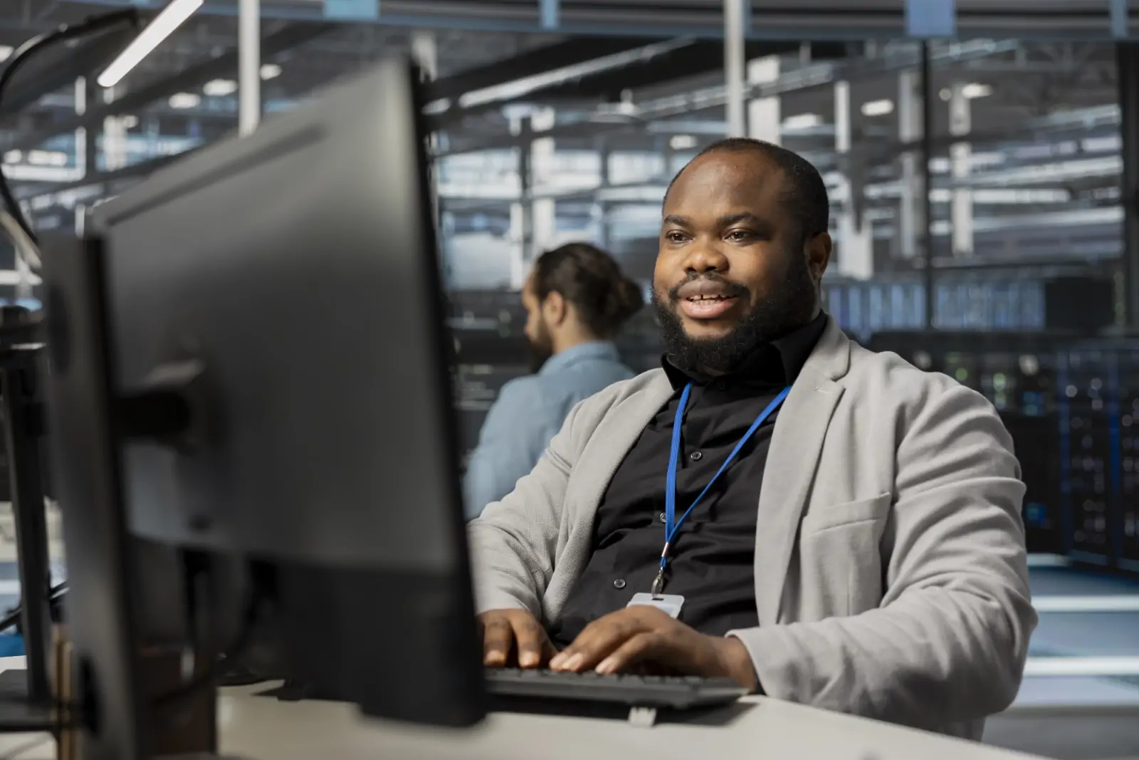 Information technology professionals collaborating around computers