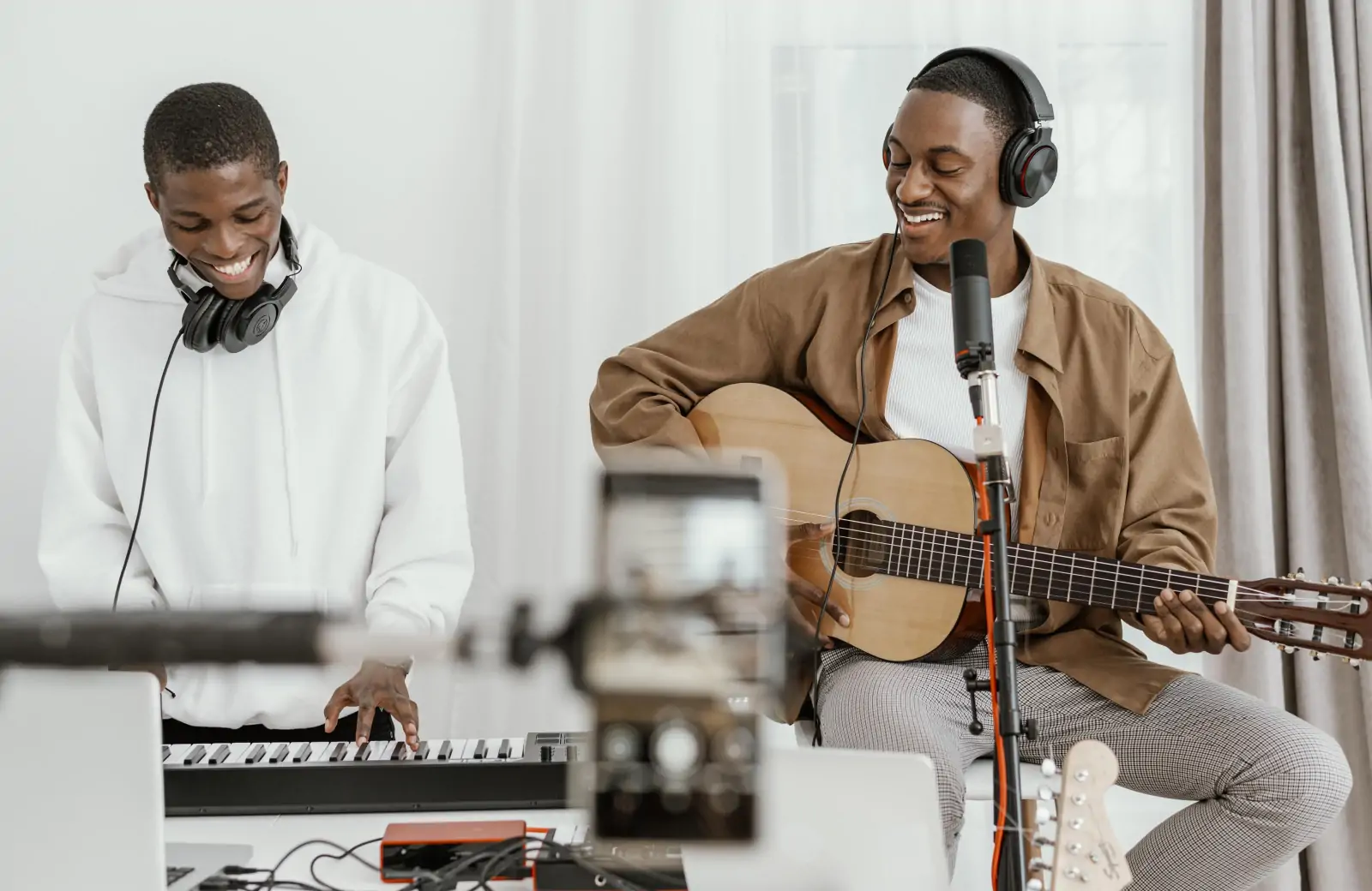 Music professionals recording vocals and instruments in a studio